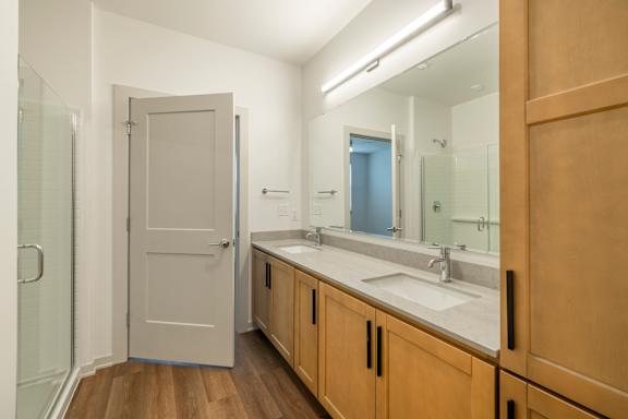 A bathroom with a white sink and a mirror.