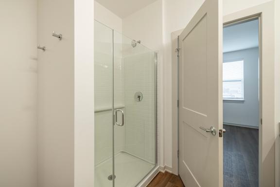 A white door with a glass panel is open.
