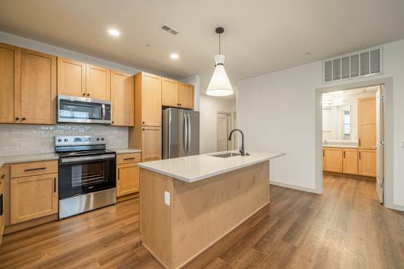 A kitchen with wooden cabinets and stainless steel appliances.