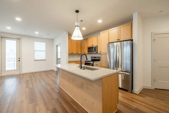 A kitchen with wooden cabinets and a white countertop.
