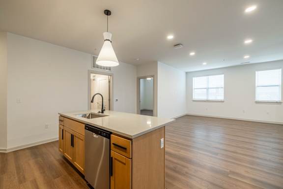 A kitchen with wooden cabinets and a white countertop.