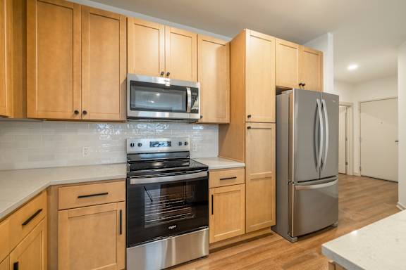 A kitchen with wooden cabinets and stainless steel appliances.