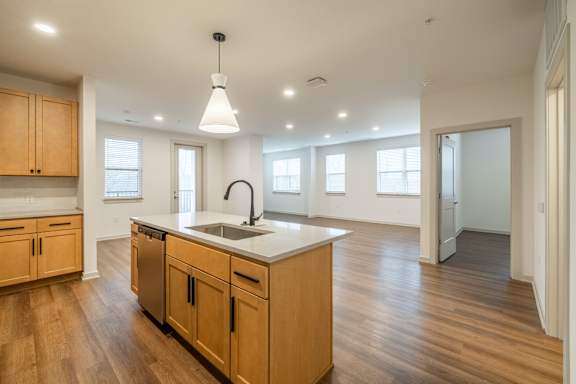 A kitchen with wooden cabinets and a white countertop.