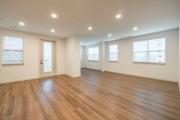 A room with wooden floors and windows.