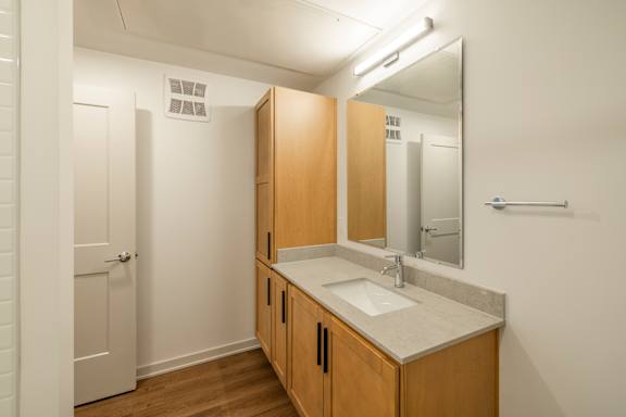 A bathroom with a sink and mirror.