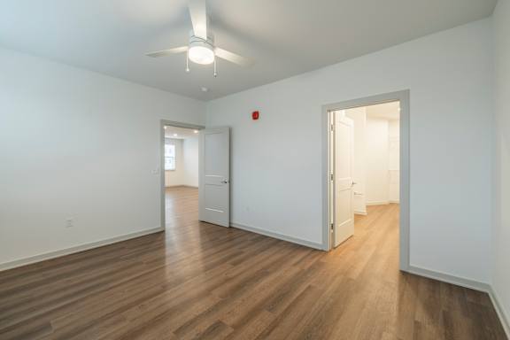 A room with wooden floors and white walls.