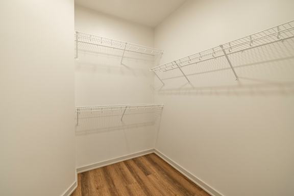 Empty room with white walls and wooden floor.