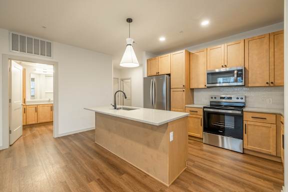 A kitchen with wooden cabinets and stainless steel appliances.