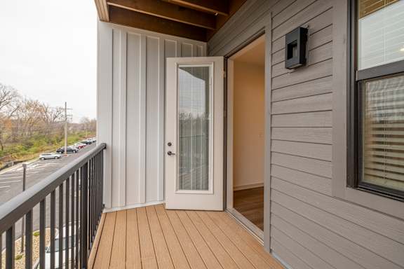 A balcony with a door and a window.