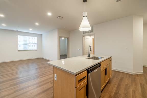 A kitchen with wooden cabinets and a white countertop.