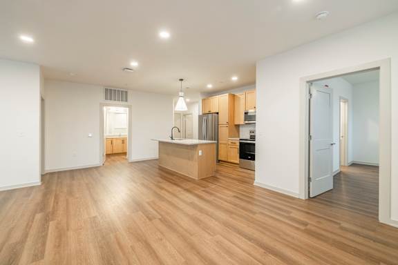 A kitchen with wooden floors and white walls.