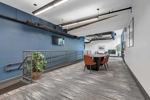 A room with a blue wall and a table with chairs.