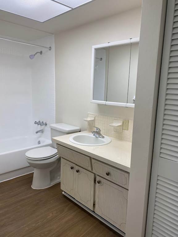A white bathroom with a toilet, sink, and mirror.