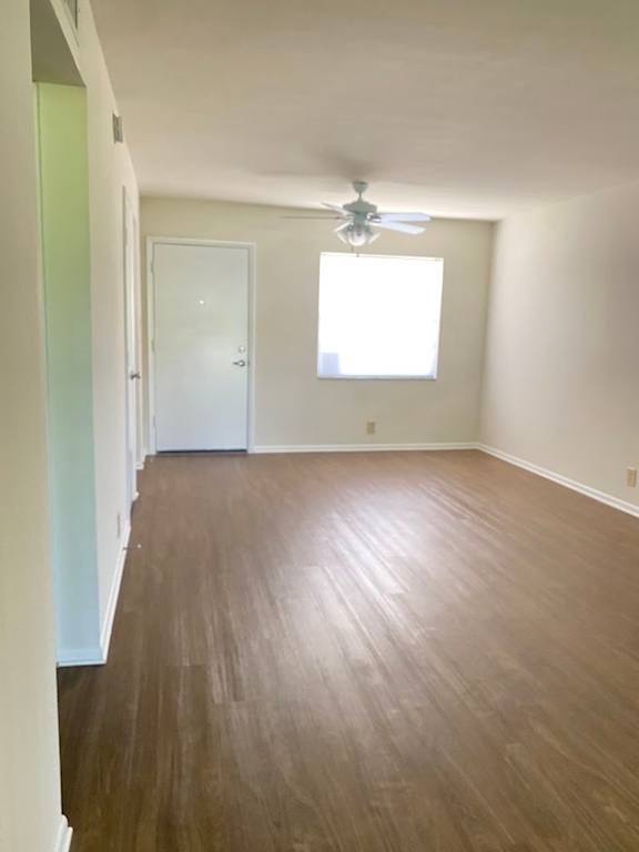 A room with a ceiling fan and a window.