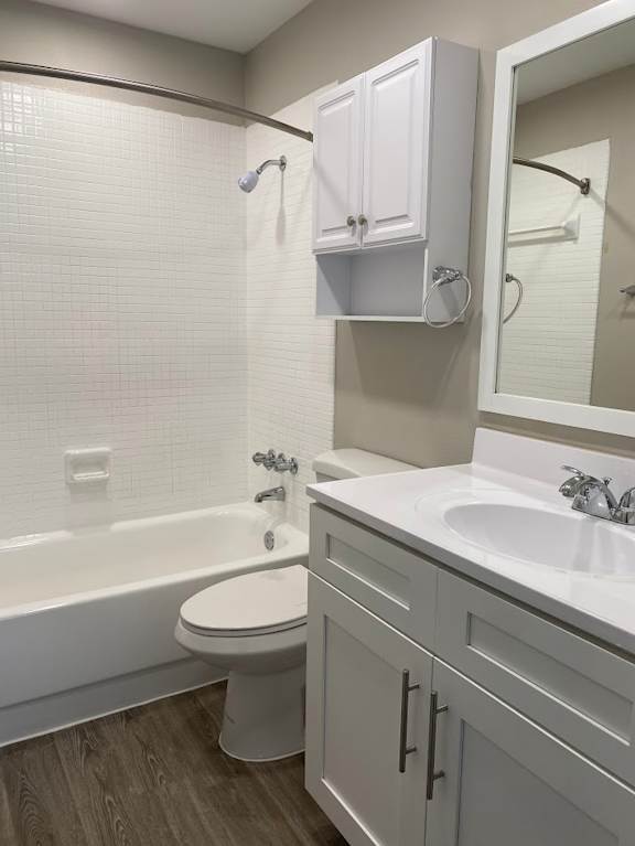 A white toilet sits next to a white sink in a bathroom.