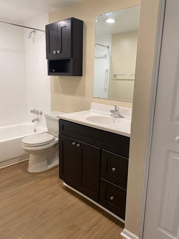 A white toilet sits next to a sink in a bathroom.