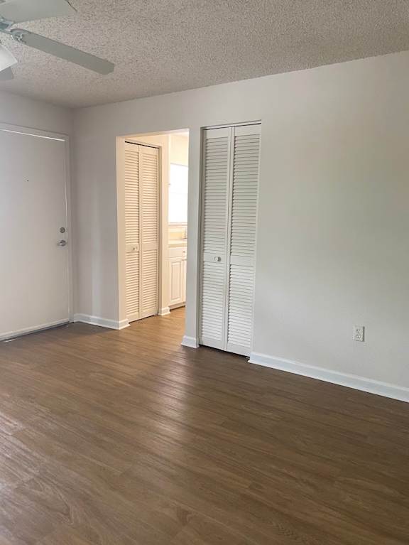 A room with a sliding door and wood flooring.