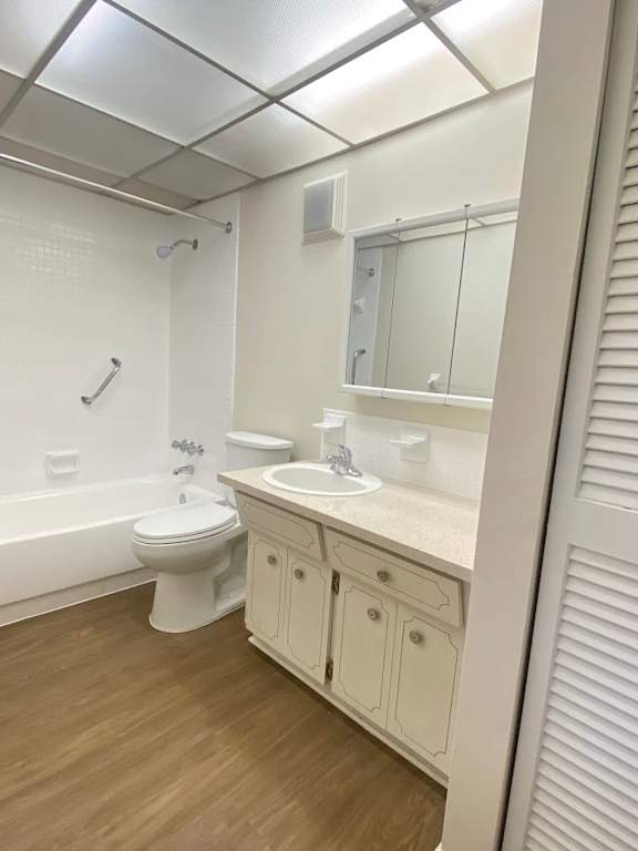 A white bathroom with a toilet, sink, and mirror.