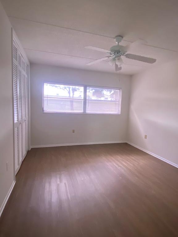 A room with a ceiling fan and a window.