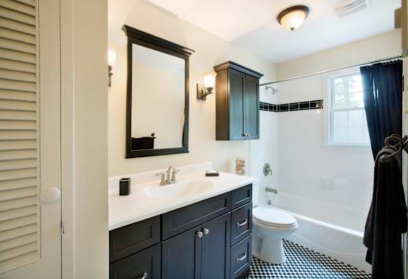 A bathroom with a black and white checkered floor at Rivercrest Apartments, Piscataway , NJ, 08854