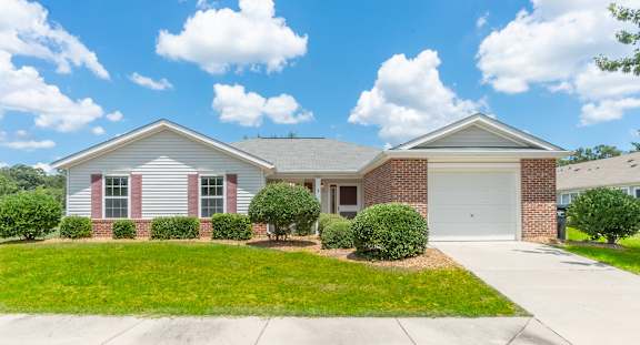 a white and brick house with a lawn in front of it  at Huntington Village **, Warner Robins, 31098