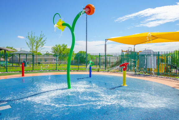 a water park with a pool and water toys  at The Village at Cottonwood Springs, Texas
