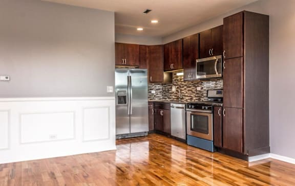 A kitchen with wooden cabinets and stainless steel appliances.
