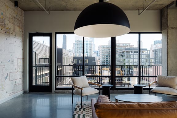 a conference room with a table and chairs and windows