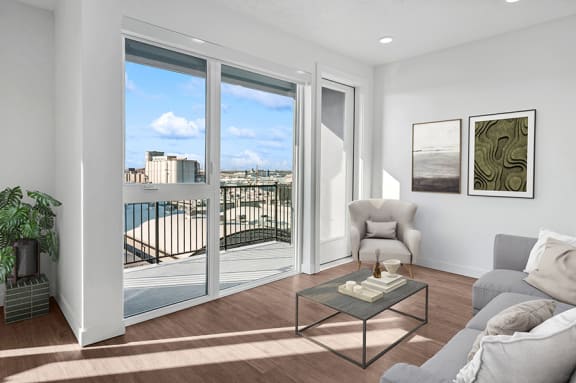 Model living room and balcony at Post House North located in Post District Residences in downtown Salt Lake City, Utah