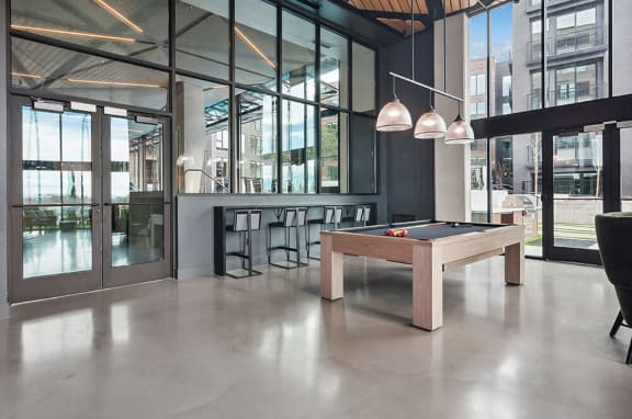 Open and airy lounge area featuring a high-end billiards table at Post District Residences in Downtown Salt Lake City, Utah