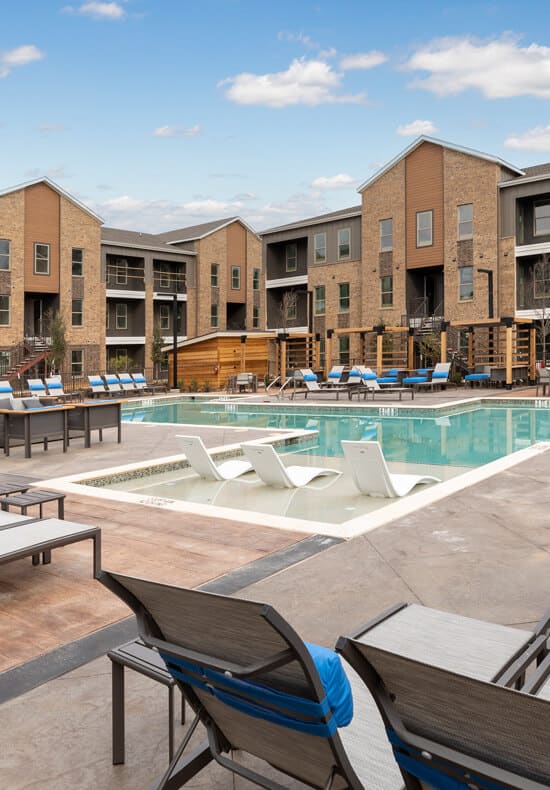 Pool loungers at Alta 3Eighty Apartments in Aubrey, Texas
