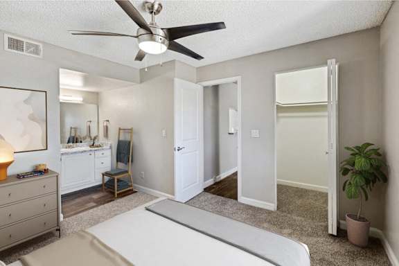 a bedroom with a bed and a ceiling fan