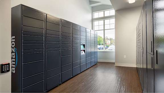 A row of Amazon lockers are lined up in a room.
