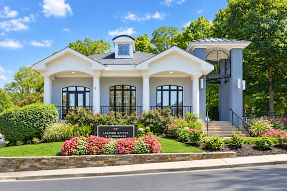 A white house with a sign that says "Leasing Office".