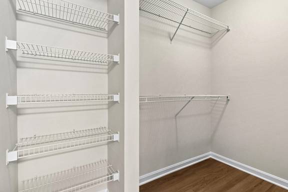 Walk-in closet with wire shelving and hanging storage at The Courts at Fair Oaks Apartments, Fairfax, Virginia