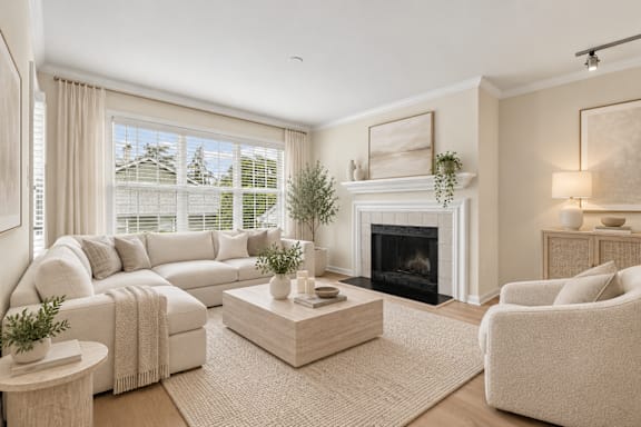 Living room with fireplace and neutral tone furniture at The Courts at Fair Oaks Apartments, Virginia, 22030