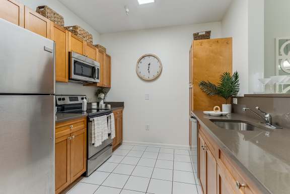 A Kitchen with a Refrigerator at Pier Village Apartments, New Jersey, 07740