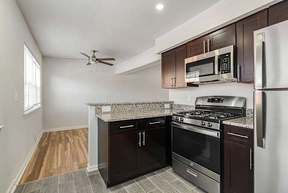 A kitchen with a stove top oven and microwave.