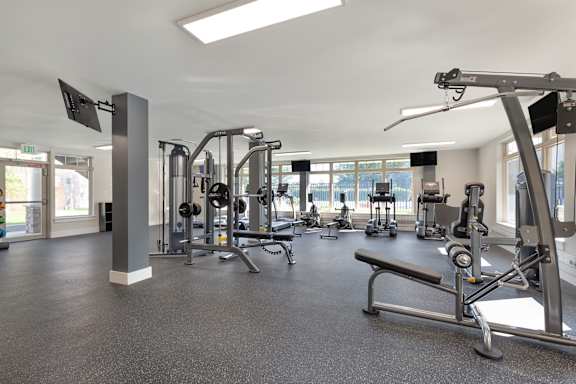 a gym with weights and other exercise equipment at Copper and Quarry Village, Maryland, 21209