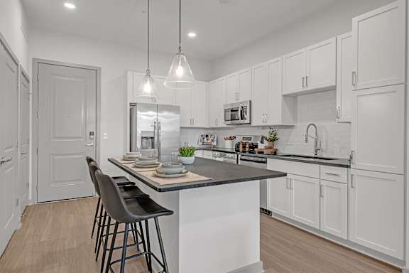 A Kitchen with White Cabinets at District 757 Apartments, Virginia, 23502
