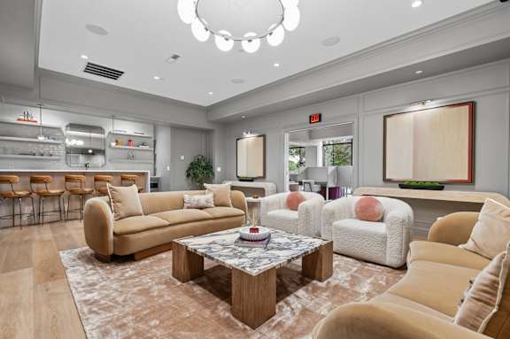 A living room with a large sectional sofa and a coffee table.