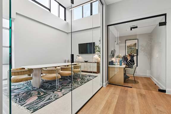 A modern room with a white table and chairs.