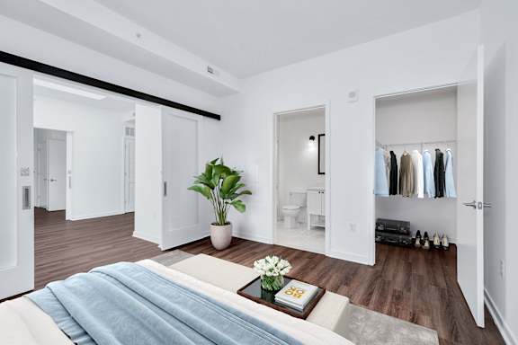 Bedroom with a plant at The Glover House Apartments, Washington