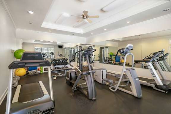 A spacious home gym with a variety of exercise equipment.