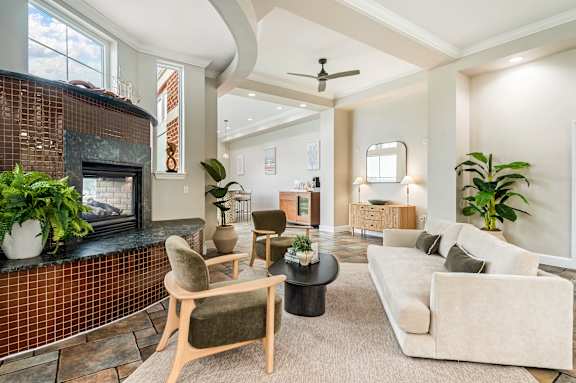A living room with a fireplace and a couch.at River House Apartments, Virginia, 23504