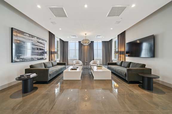 A modern living room with two sofas and a coffee table.
