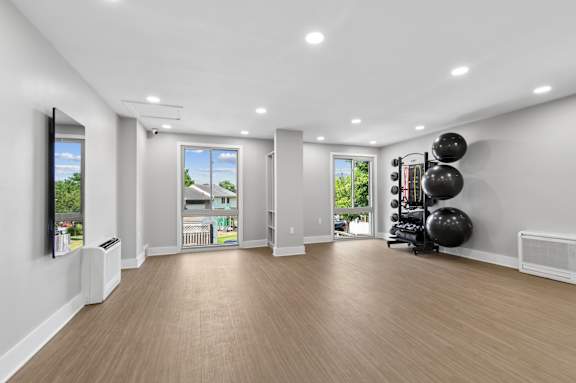A spacious room with wooden flooring and a balloon wall decoration.