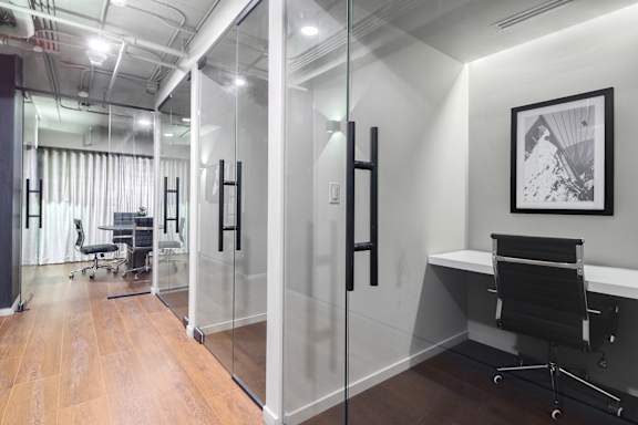 Modern conference room with glass walls and black accents at The Hamilton Apartments, Florida