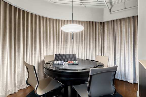 Poker table room with modern pendant lighting at The Hamilton Apartments, Miami, FL