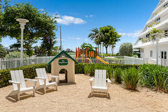 Pet friendly dog park area with seating at The Hamilton Apartments, Miami